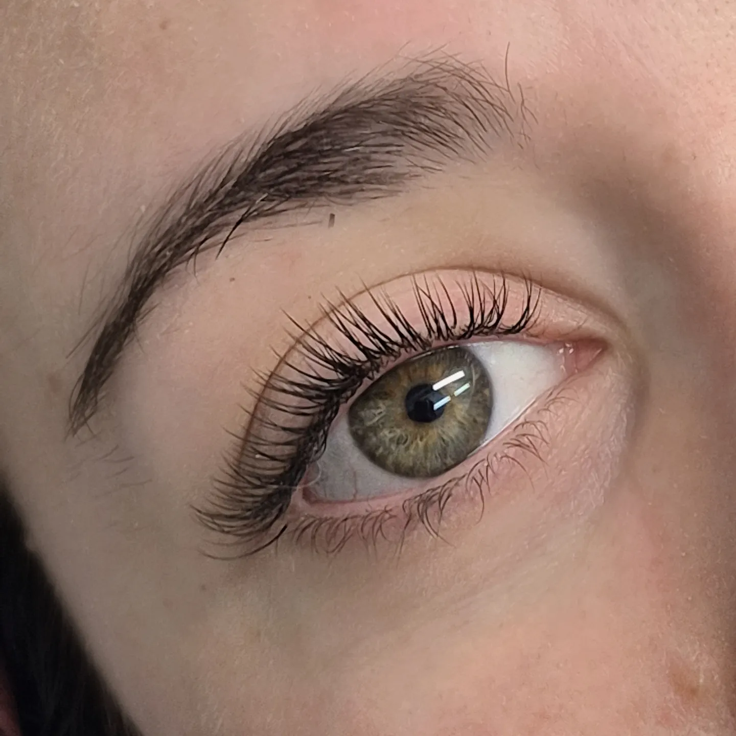 Natural lash lift and groomed brow on a green eye