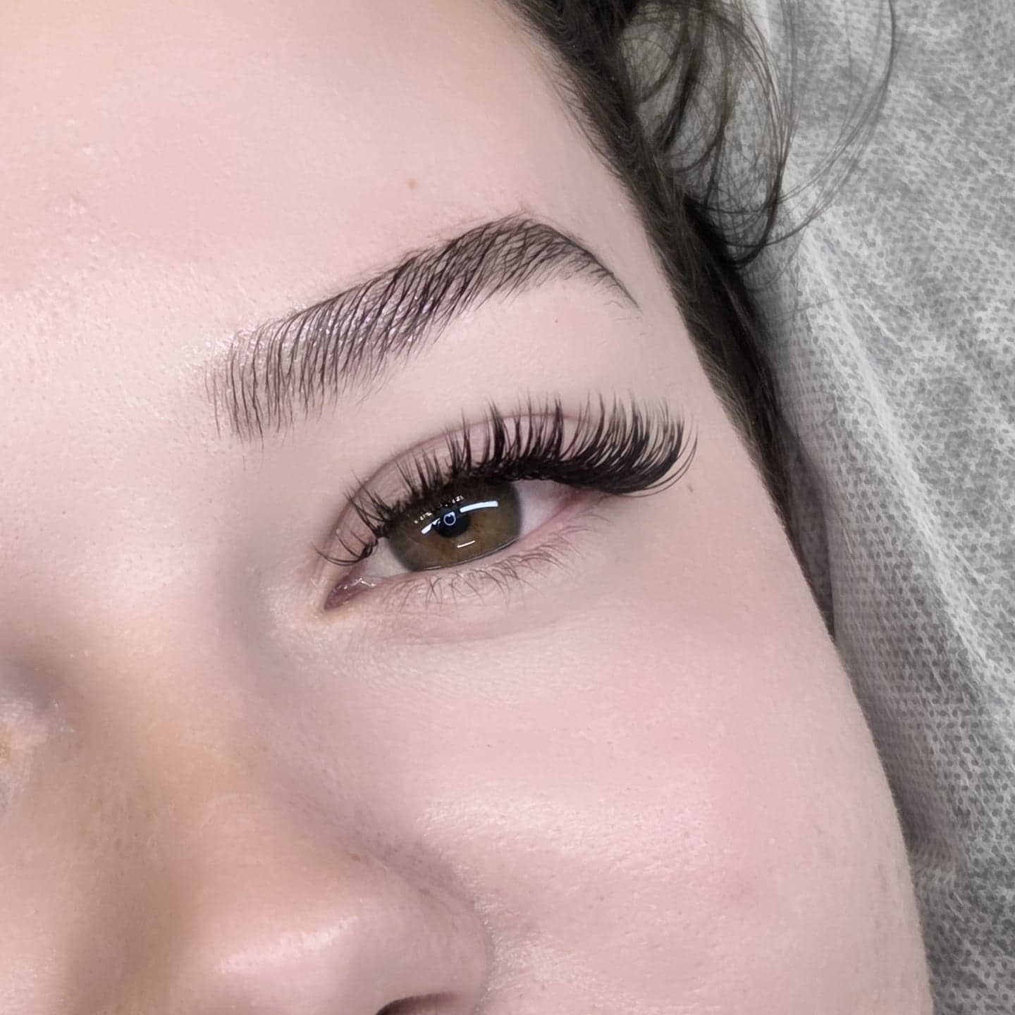 Close up of volume lash extensions on a brown eye
