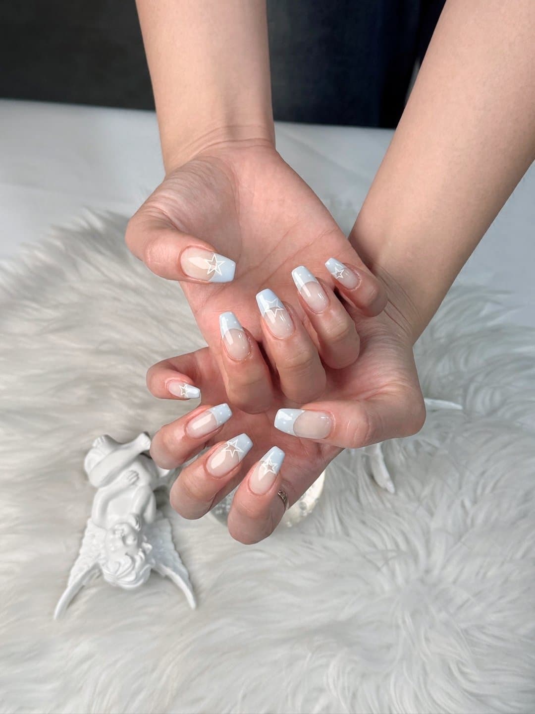 Baby blue French tips with white star nail art
